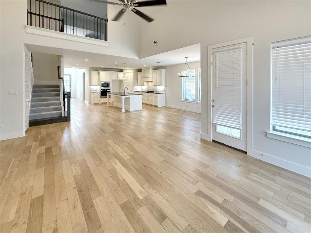 5924 Owen Road McKinney, TX 75071 - Photo 8 of 40 a view of a living room and kitchen with furniture wooden floor