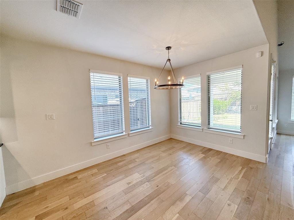 5924 Owen Road McKinney, TX 75071 - Photo 9 of 40 an empty room with wooden floor and windows