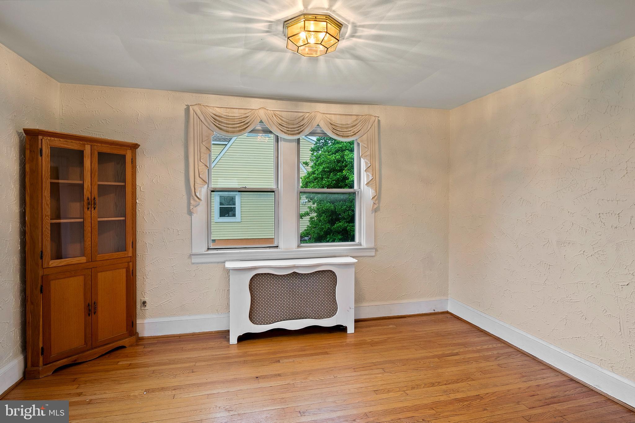 1240 Greystone Road Halethorpe, MD 21227 - Photo 11 of 41 a view of an empty room with a window and wooden floor