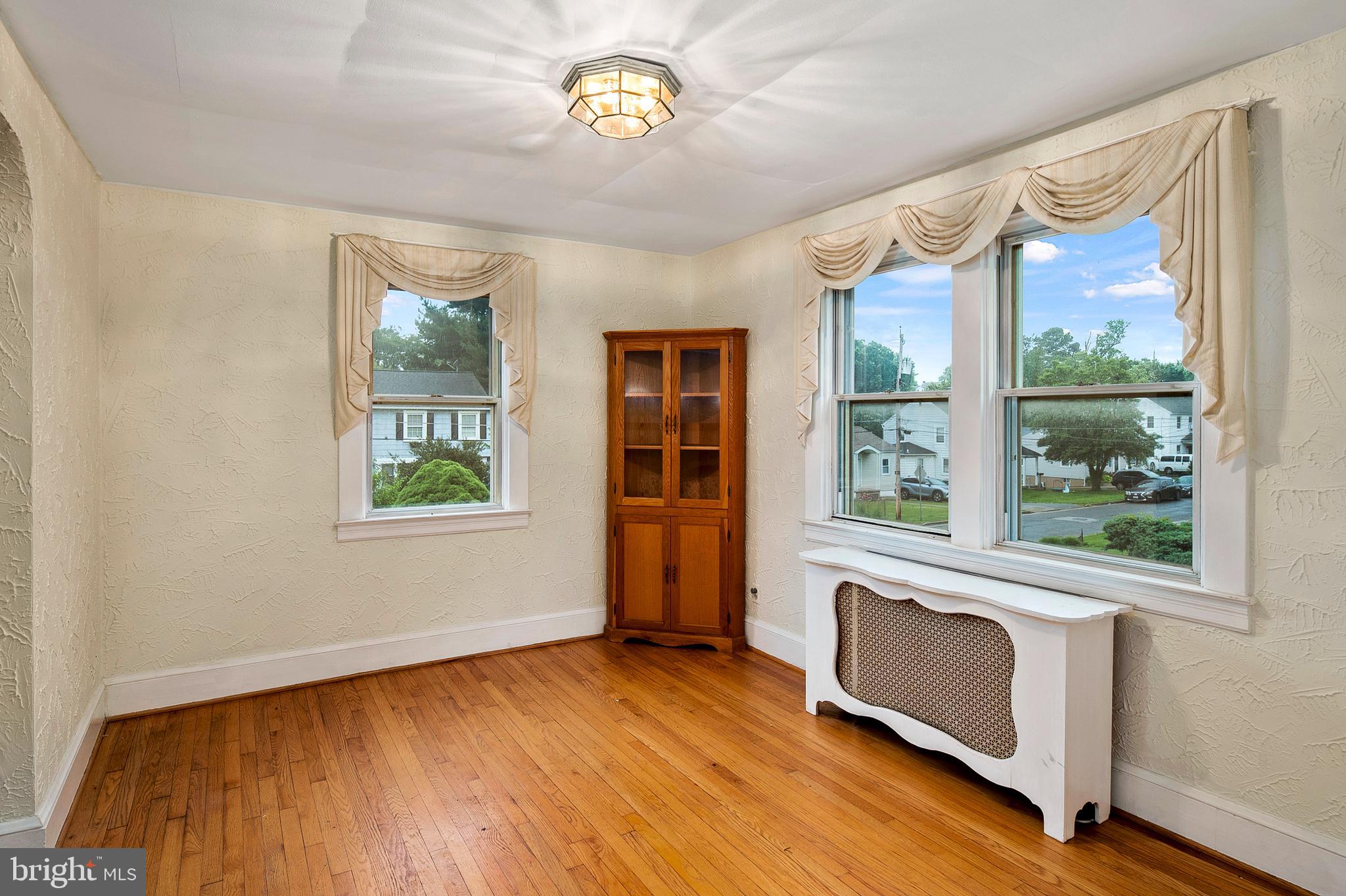 1240 Greystone Road Halethorpe, MD 21227 - Photo 12 of 41 a view of an empty room with a window and wooden floor