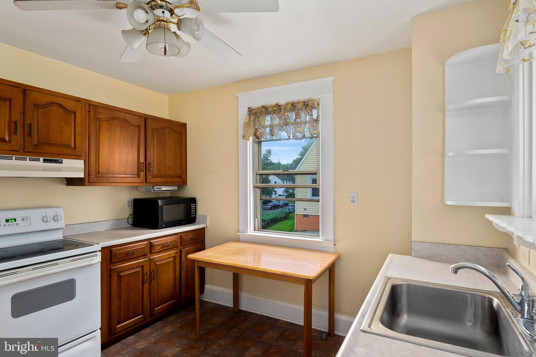 1240 Greystone Road Halethorpe, MD 21227 - Photo 15 of 41 a kitchen with stainless steel appliances a stove a sink cabinets and a window