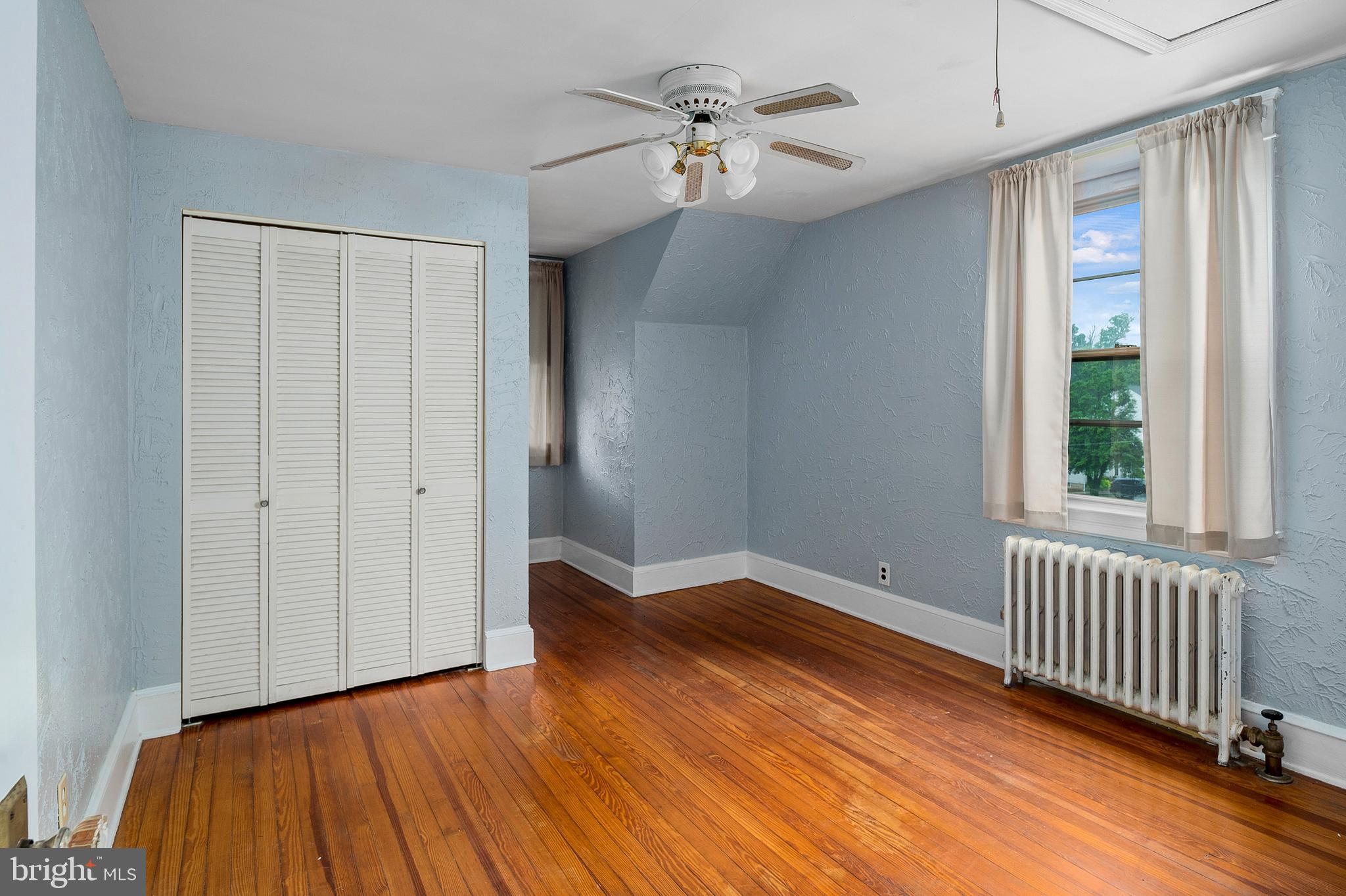 1240 Greystone Road Halethorpe, MD 21227 - Photo 27 of 41 a view of empty room with wooden floor and fan
