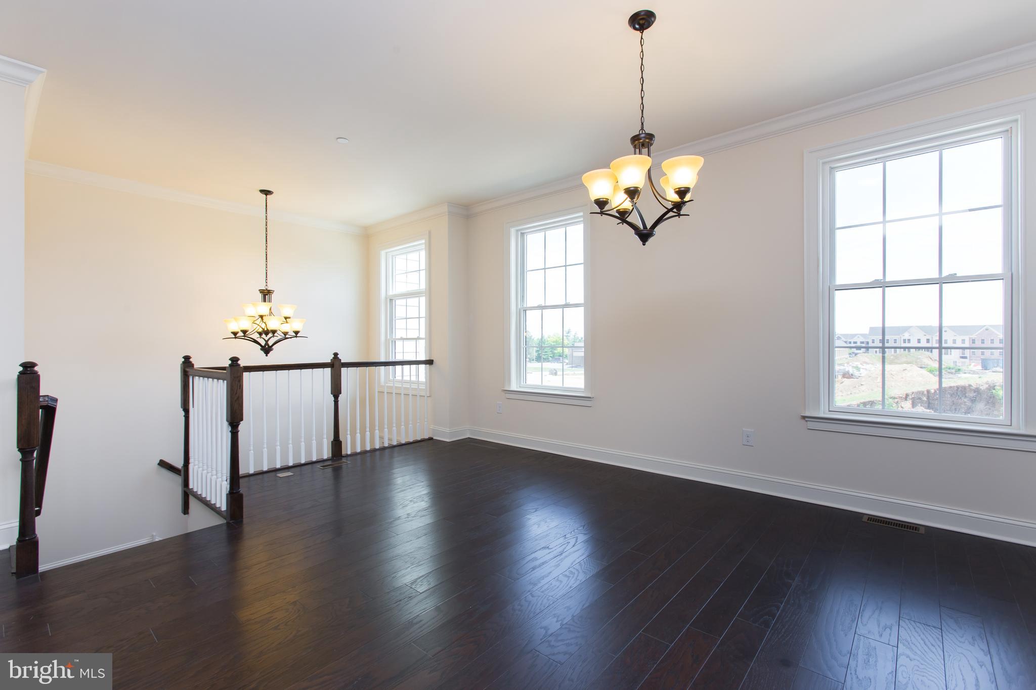 18 Parkview Cir. Wayne, PA 19087 - Photo 4 of 33 a view of a room with wooden floor chandelier and windows