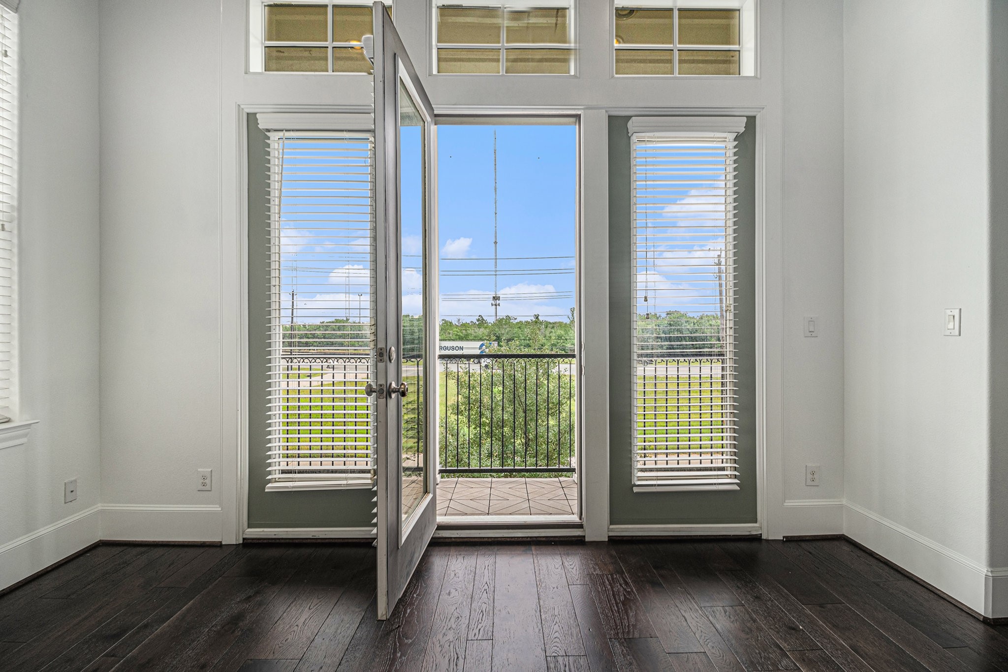 9674 Knight Road Houston, TX 77045 - Photo 8 of 21 an empty room with wooden floor and windows