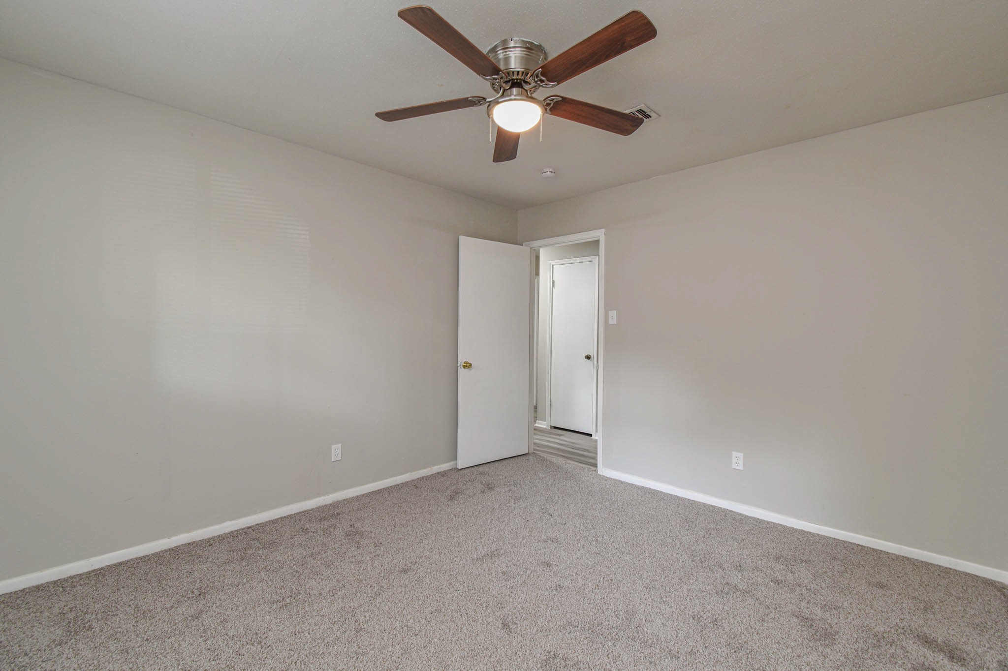 17311 Methil Drive Spring, TX 77379 - Photo 18 of 24 an empty room with a ceiling fan and a window