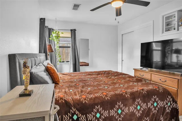 a bedroom with a bed and a flat screen tv