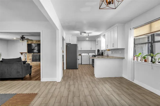 a kitchen with a refrigerator and a stove top oven