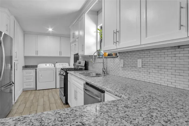 a kitchen with a sink stove and cabinets