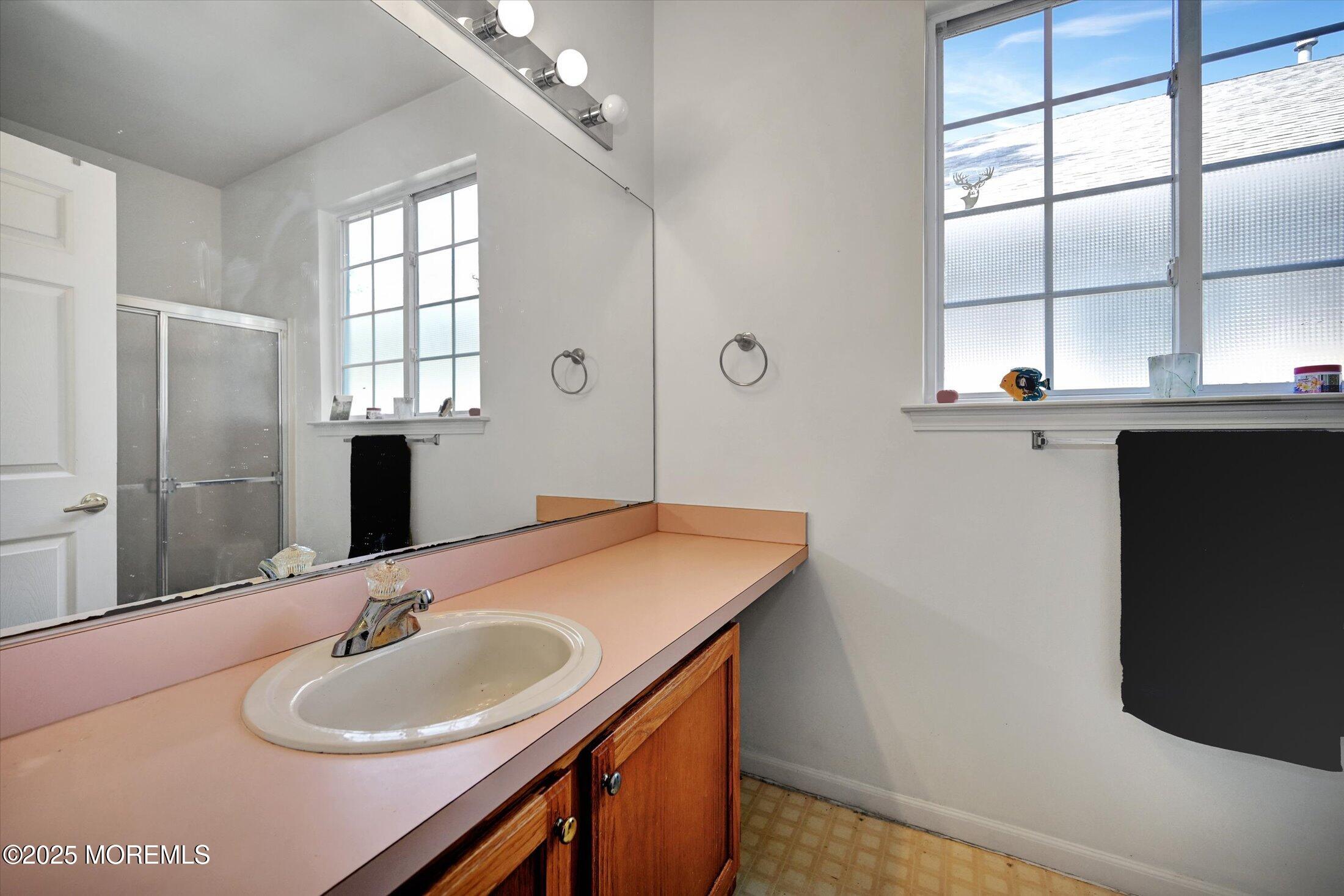 56 Quail Road Barnegat, NJ 08005 - Photo 17 of 30 a bathroom with a sink and a mirror
