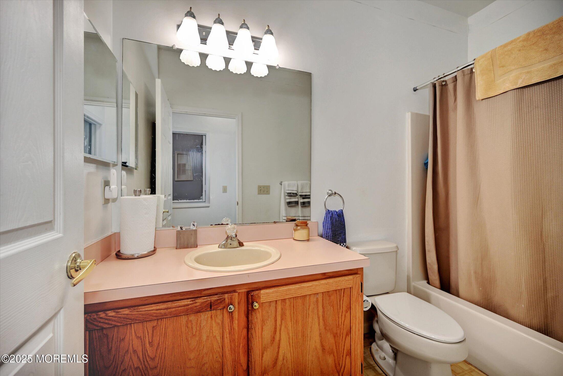 56 Quail Road Barnegat, NJ 08005 - Photo 20 of 30 a bathroom with a sink a toilet and a mirror