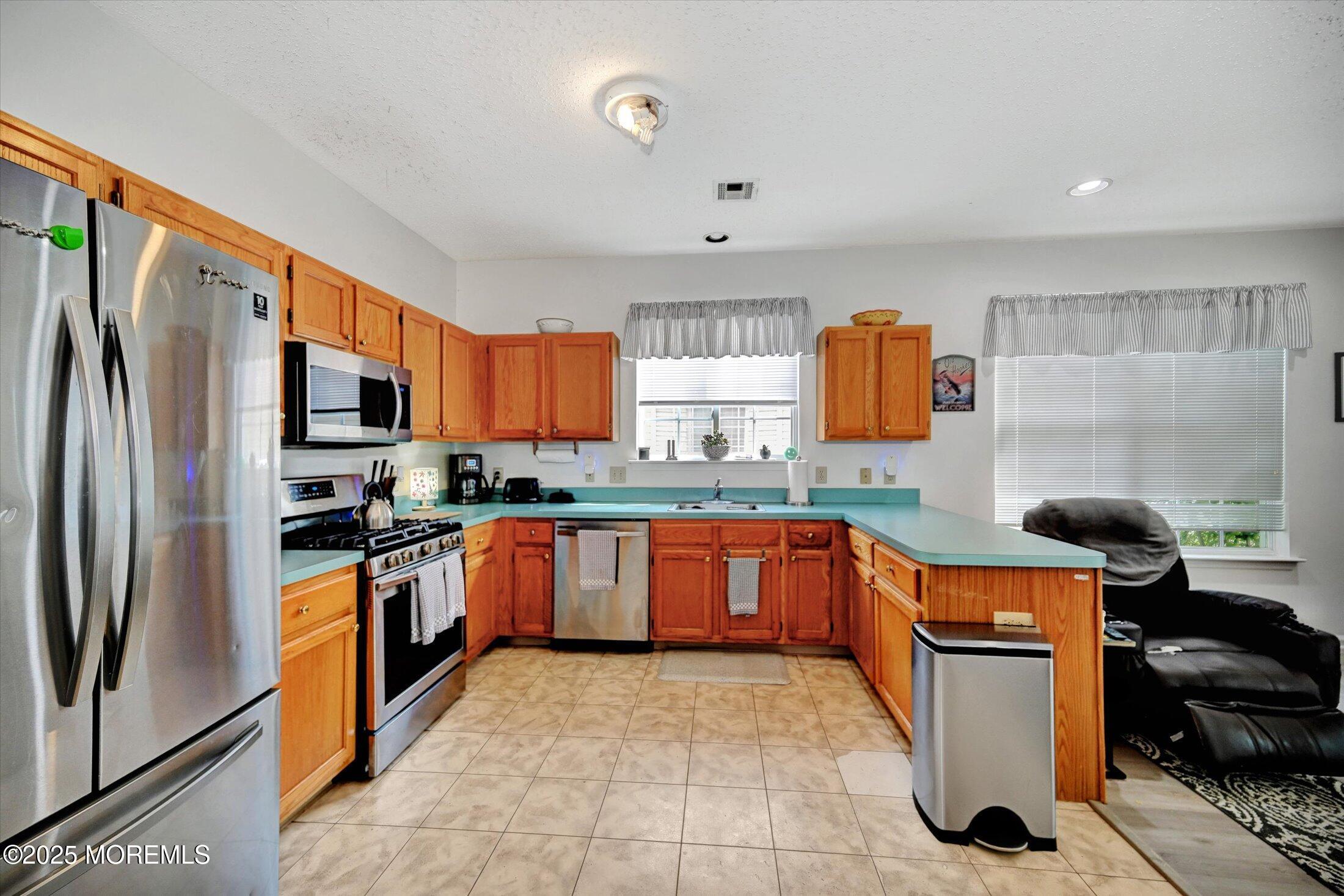 56 Quail Road Barnegat, NJ 08005 - Photo 8 of 30 a kitchen with stainless steel appliances granite countertop a refrigerator stove top oven a sink and dishwasher