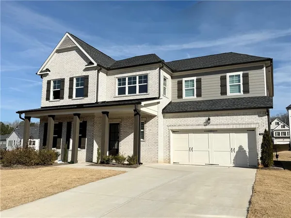 a front view of a house with a yard