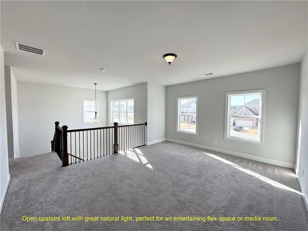a view of a livingroom with a staircase and window