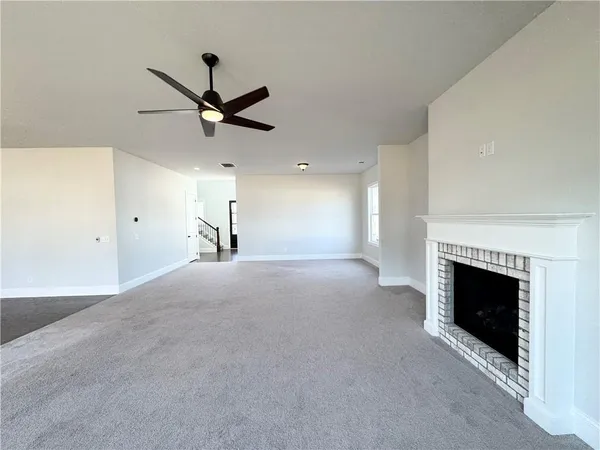 a view of an empty room with a fireplace
