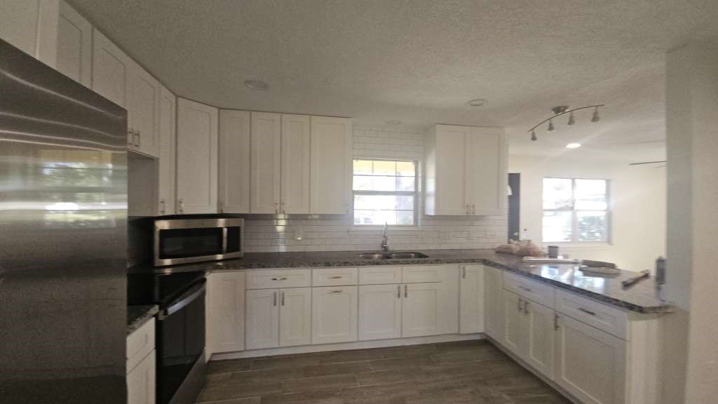 a kitchen with a sink stove and refrigerator