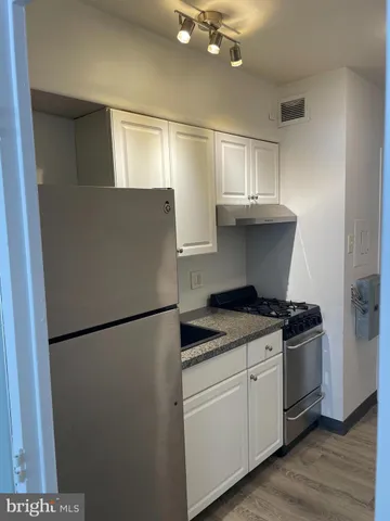a kitchen with a stove and a refrigerator