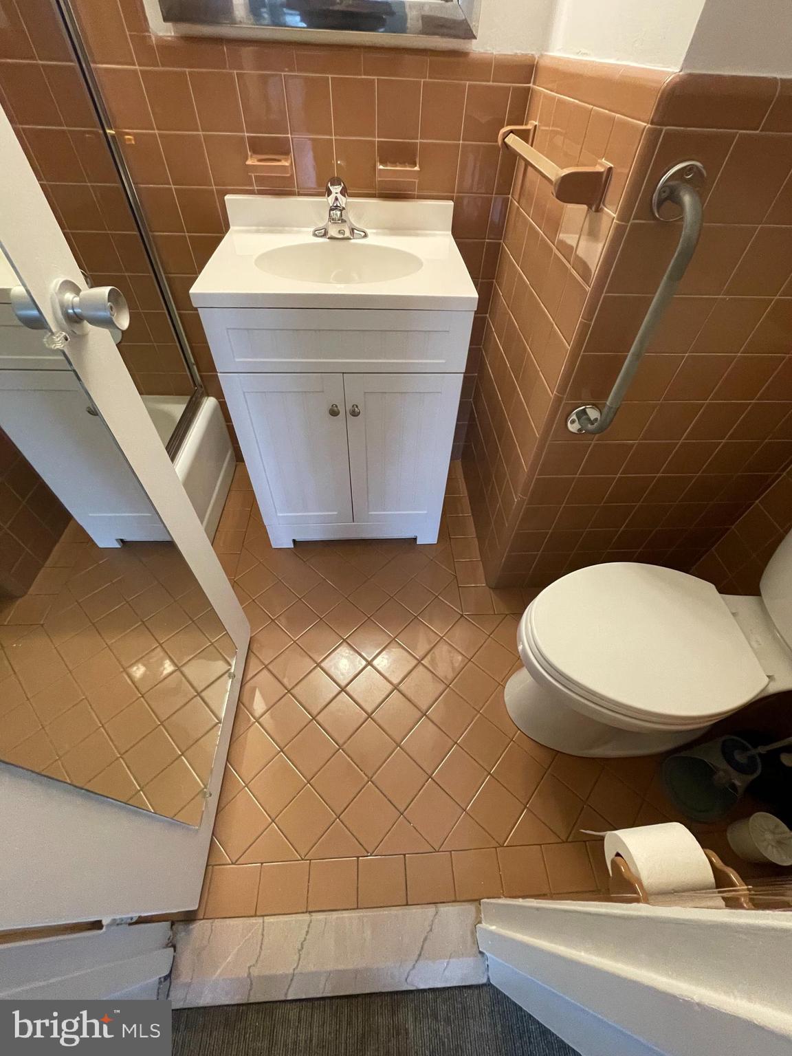 7900 Old York Road, Unit 311B Elkins Park, PA 19027 - Photo 13 of 22 a bathroom with a sink a toilet and mirror