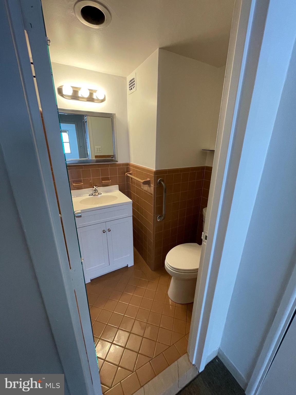 7900 Old York Road, Unit 311B Elkins Park, PA 19027 - Photo 7 of 22 a bathroom with a granite countertop toilet sink and mirror