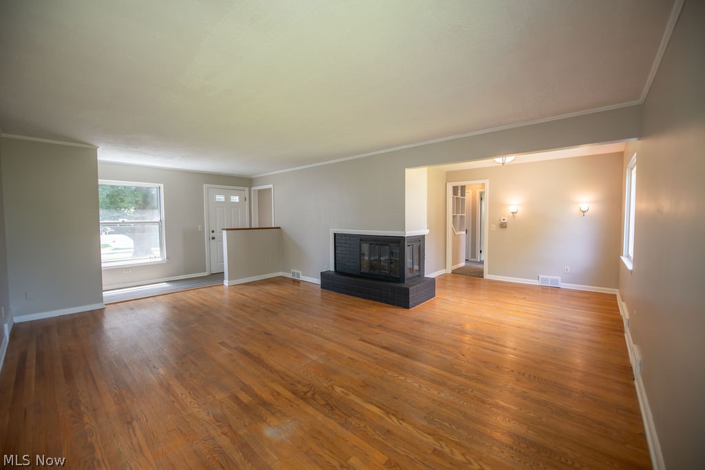 4221 2nd Street Northwest Canton, OH 44708 - Photo 9 of 35 Living room view featuring a fireplace and an abundance of natural light.