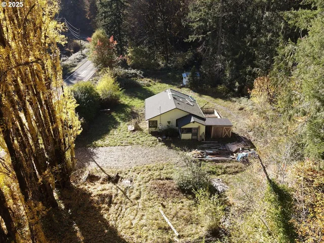 a backyard of a house with table and chairs