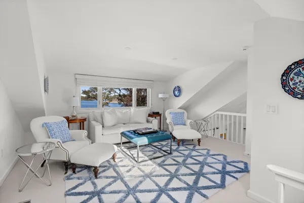 a living room with furniture and a stairs