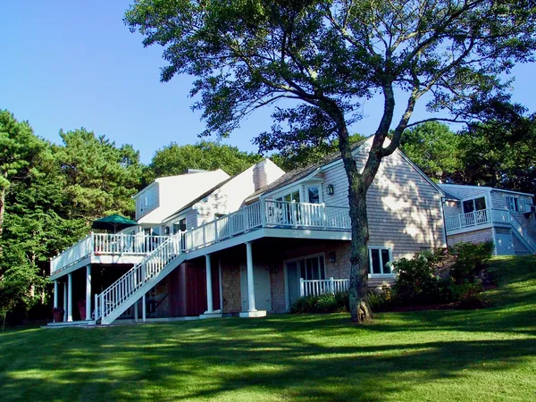 a front view of a house with a garden