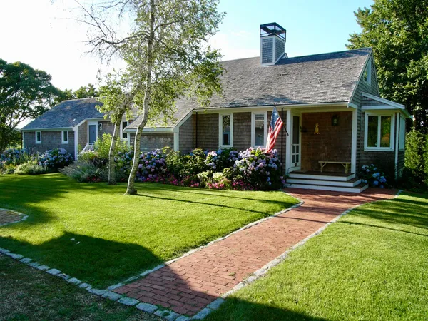 a front view of house with yard and green space