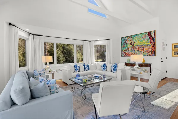 a kitchen with white cabinets and sink