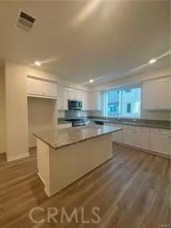 a large kitchen with stainless steel appliances granite countertop a sink and a stove