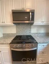 a stove top oven sitting inside of a kitchen