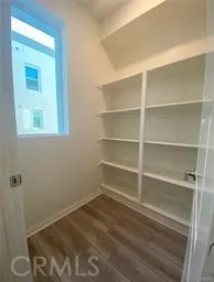 a room with a hardwood floor and a window