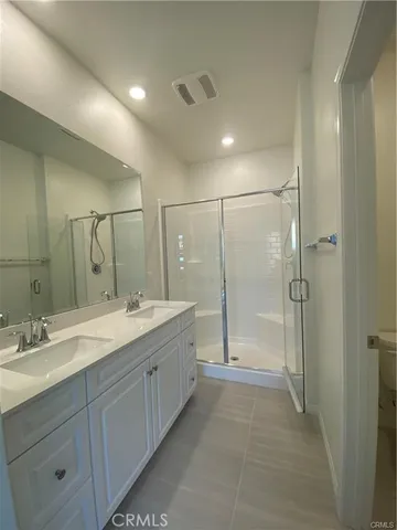 a bathroom with a shower sink and mirror