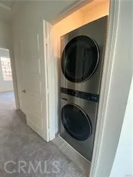 a view of a hallway with washer and dryer