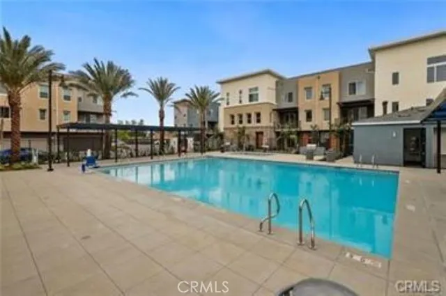 a view of multiple houses with outdoor space and seating area