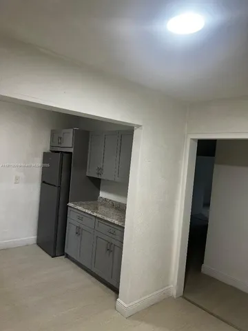 a kitchen with cabinets and steel appliances