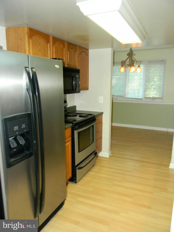 1735 Quantico Road Edgewater, MD 21037 - Photo 6 of 30 a kitchen with stainless steel appliances a refrigerator and a sink