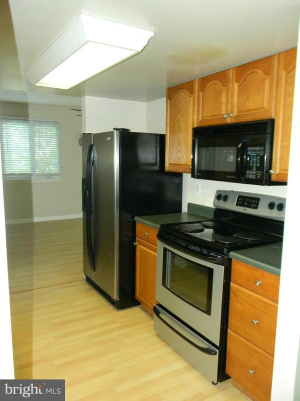 1735 Quantico Road Edgewater, MD 21037 - Photo 8 of 30 a kitchen with stainless steel appliances granite countertop a stove a refrigerator and a microwave