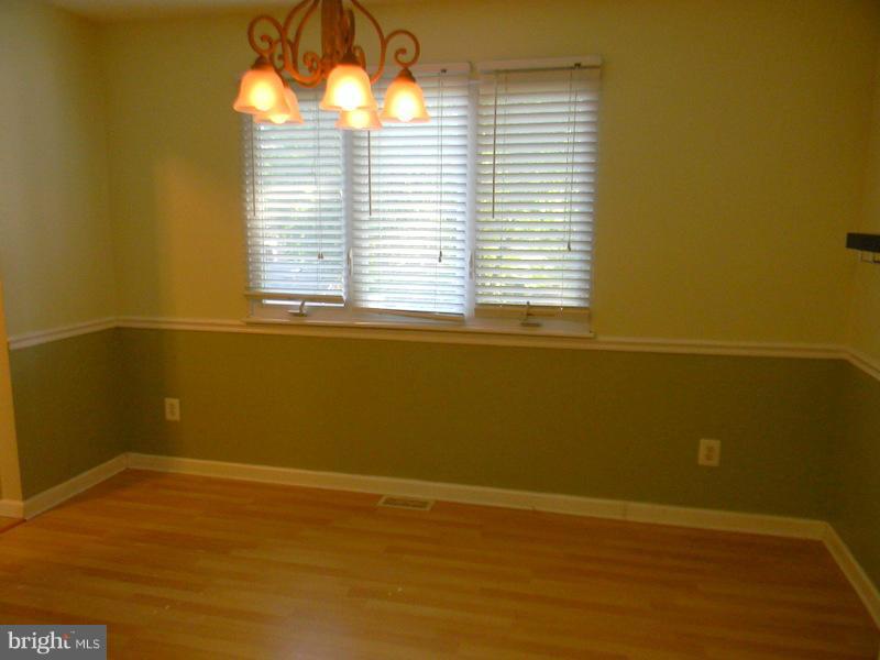 1735 Quantico Road Edgewater, MD 21037 - Photo 9 of 30 a view of a small space with wooden floor and a window