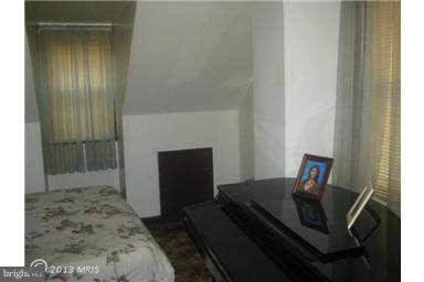 5630 Johnnycake Road Baltimore, MD 21207 - Photo 16 of 19 a bedroom with a bed and a mirror