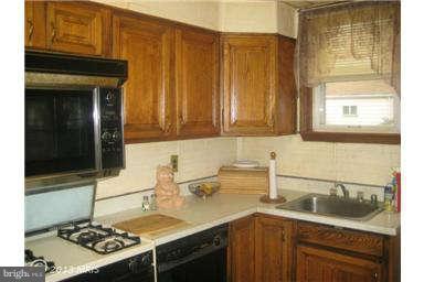 5630 Johnnycake Road Baltimore, MD 21207 - Photo 7 of 19 a kitchen with a sink stove and cabinets