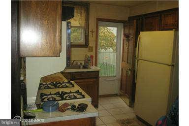 5630 Johnnycake Road Baltimore, MD 21207 - Photo 8 of 19 a kitchen with a refrigerator and a stove