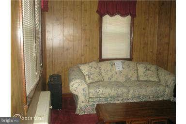 5630 Johnnycake Road Baltimore, MD 21207 - Photo 9 of 19 a living room with furniture and a fireplace