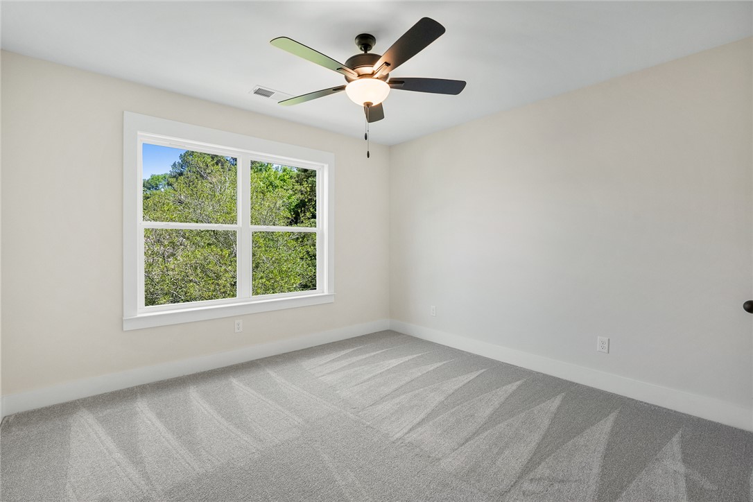 100 Garden Gate Drive Anderson, SC 29621 - Photo 32 of 43 This bright room features abundant natural light and soft carpeting, creating a serene and comfortable atmosphere.