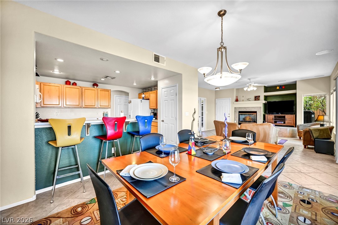 10730 Amber Ridge Drive, Unit 101 Las Vegas, NV 89144 - Photo 11 of 32 An open concept design seamlessly connects the dining area, kitchen, and living space, perfect for entertaining.