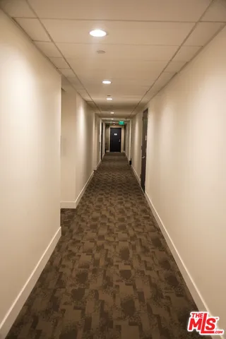 a kitchen with a sink a refrigerator and chandelier