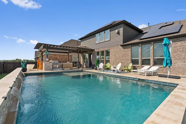 a view of a swimming pool with a lounge chairs