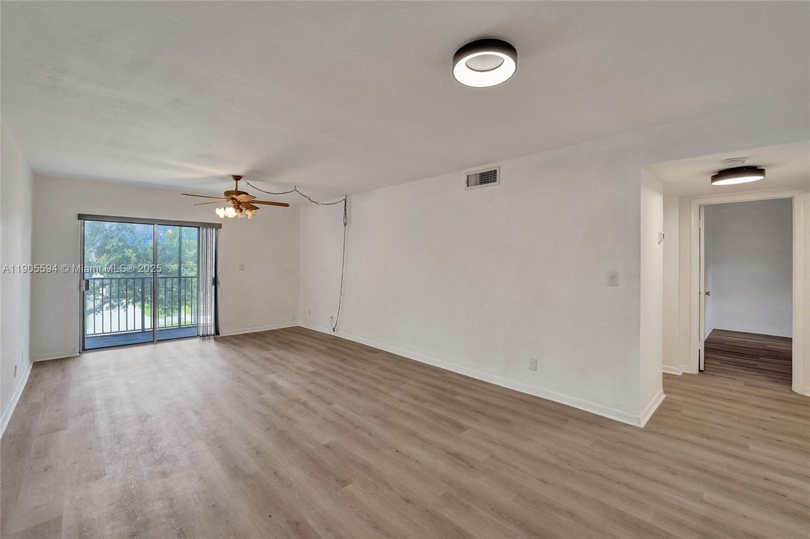 7541 Northwest 16th Street, Unit 1310 Plantation, FL 33313 - Photo 17 of 46 an empty room with wooden floor and windows