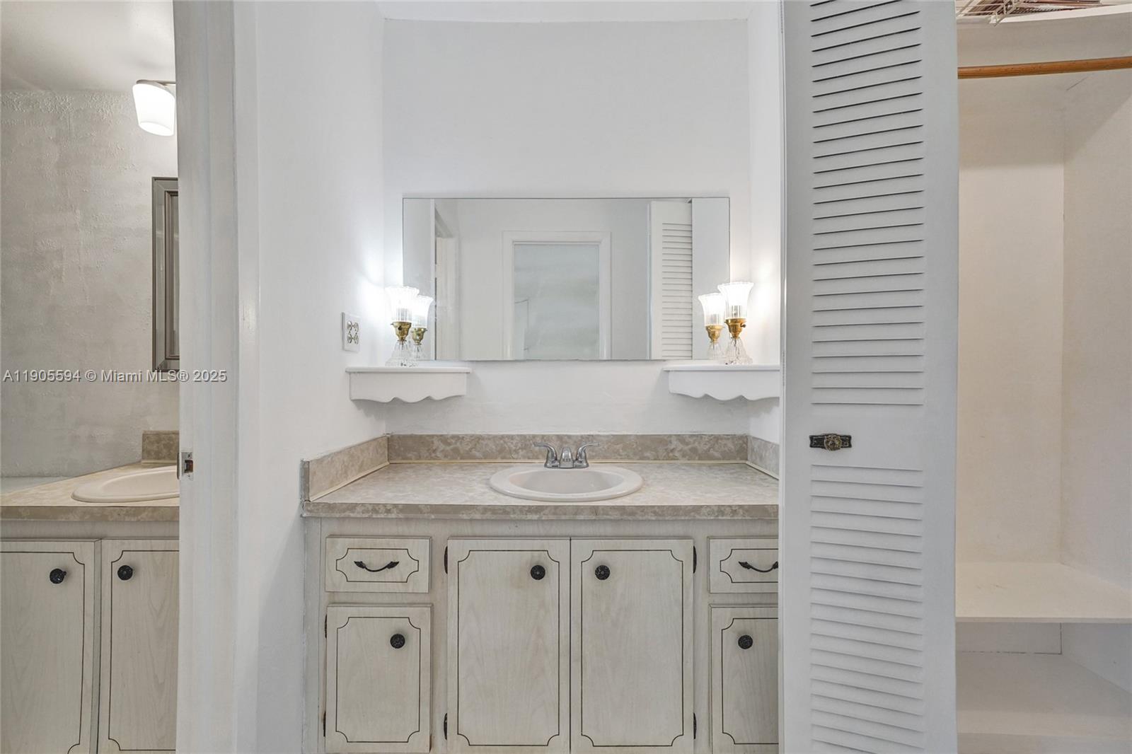 7541 Northwest 16th Street, Unit 1310 Plantation, FL 33313 - Photo 25 of 46 a bathroom with a granite countertop sink and a mirror