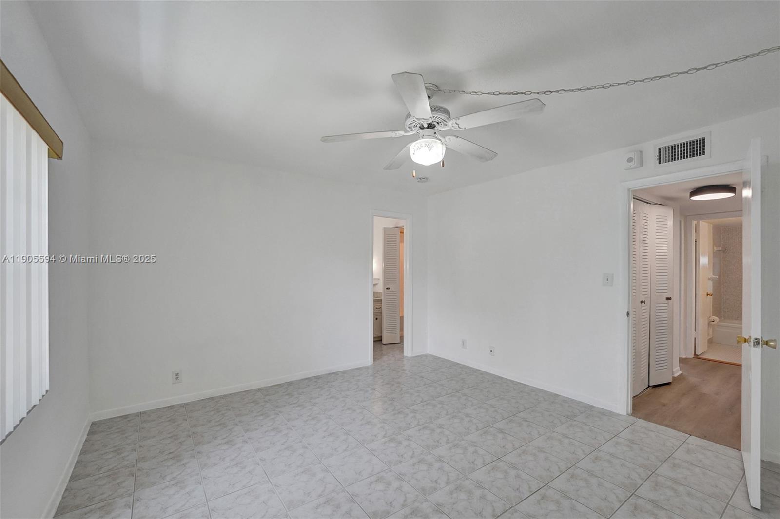 7541 Northwest 16th Street, Unit 1310 Plantation, FL 33313 - Photo 29 of 46 an empty room with closet and a ceiling fan