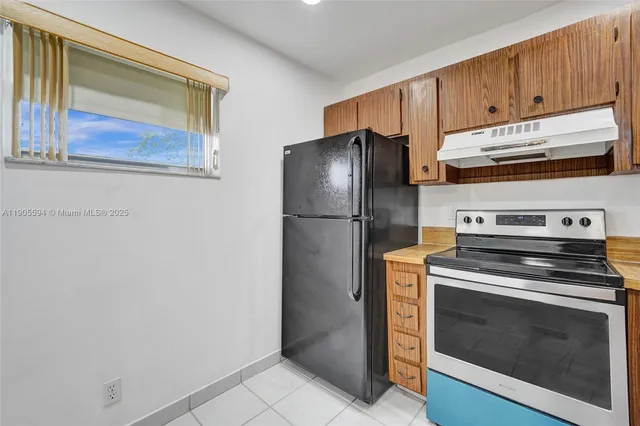 a kitchen with cabinets and stainless steel appliances